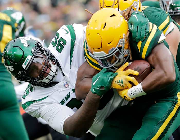 Jets' DT Quinnen Williams stop Packers' RB Aaron Jones in a 2022 game at Lambeau Field